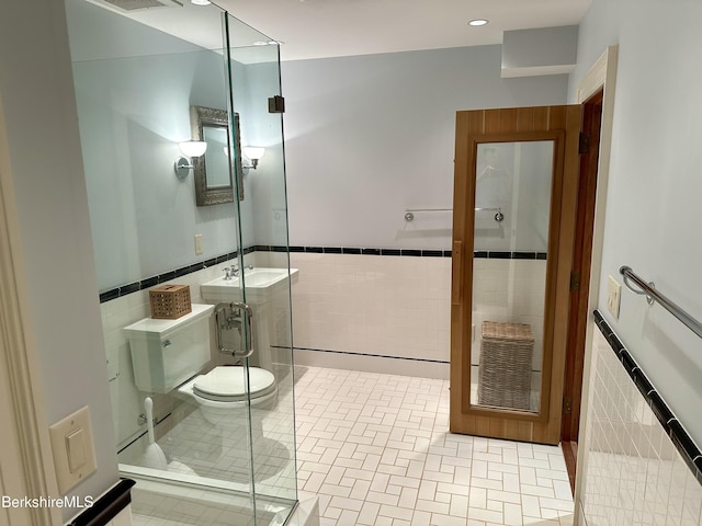 258 Sandisfield Rd, New Marlborough, MA 01230 - bathroom featuring tile walls, toilet, wainscoting, a shower stall, and recessed lighting