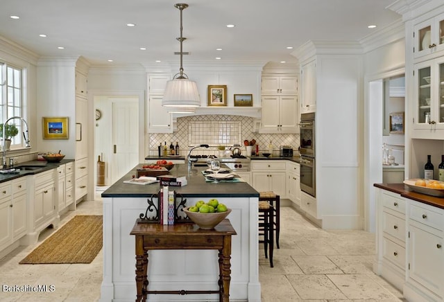 258 Sandisfield Rd, New Marlborough, MA 01230 - kitchen with a sink, dark countertops, a breakfast bar area, stainless steel double oven, and recessed lighting