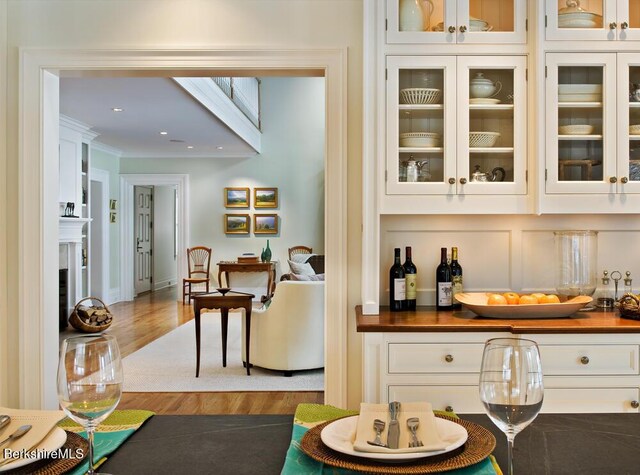 258 Sandisfield Rd, New Marlborough, MA 01230 - indoor dry bar featuring wood finished floors, a fireplace, recessed lighting, and ornamental molding
