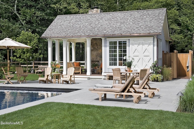 258 Sandisfield Rd, New Marlborough, MA 01230 - view of pool house with an outdoor pool