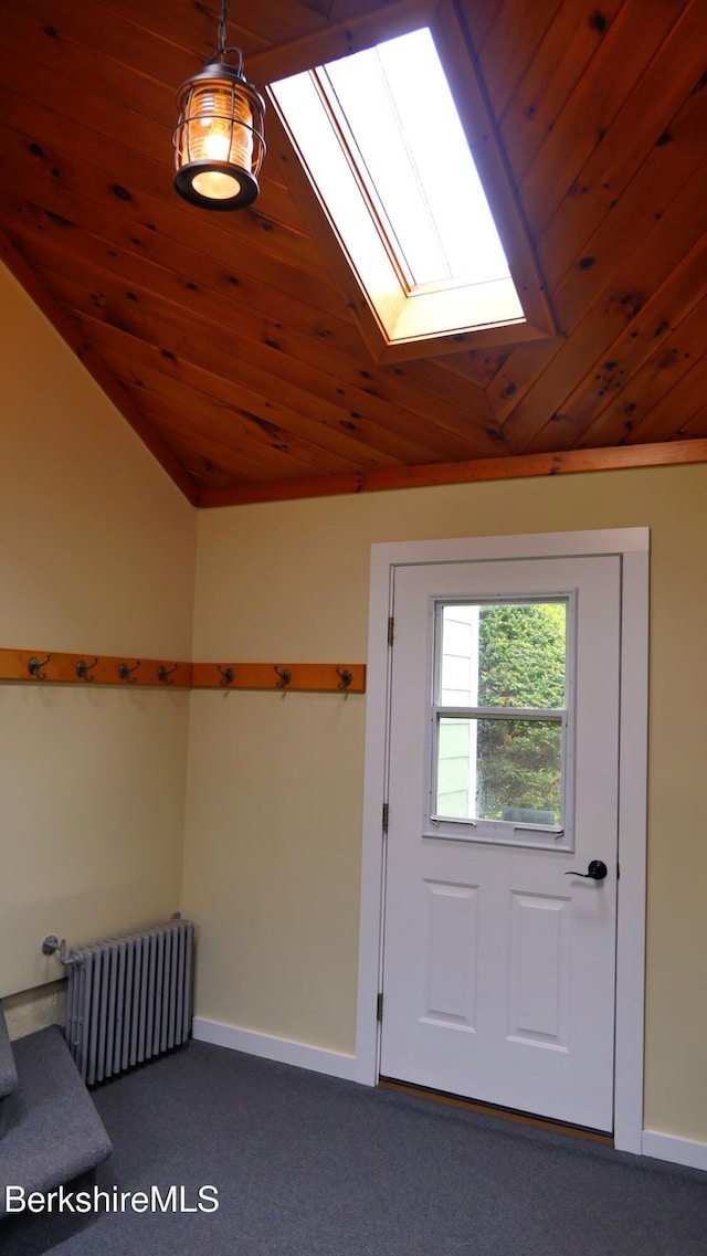 366 Clough Rd, Stamford, VT 05352 - doorway to outside featuring radiator heating unit, a skylight, wooden ceiling, dark colored carpet, and lofted ceiling