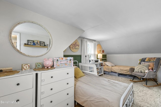 carpeted bedroom featuring lofted ceiling