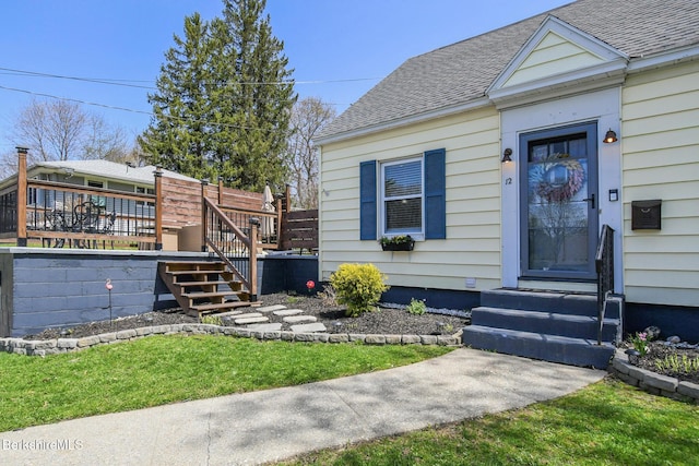 exterior space featuring a deck and a shingled roof