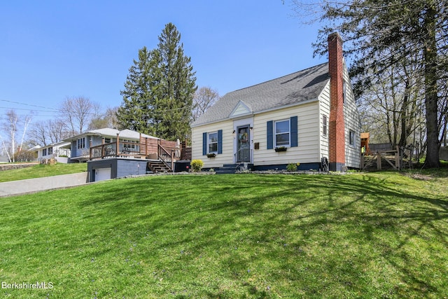cape cod-style house with a deck, an attached garage, a chimney, and a front yard