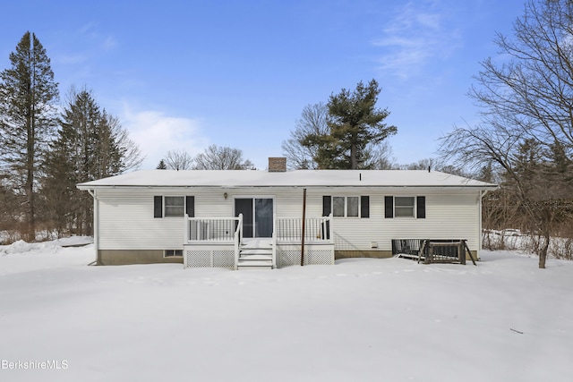 snow covered house featuring a wooden deck