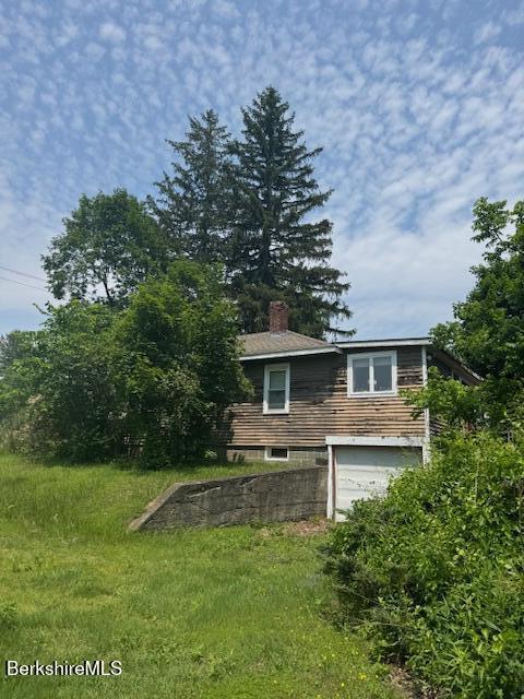 386 N Plain Rd, Great Barrington, MA 01230 - view of home's exterior featuring a chimney and an attached garage