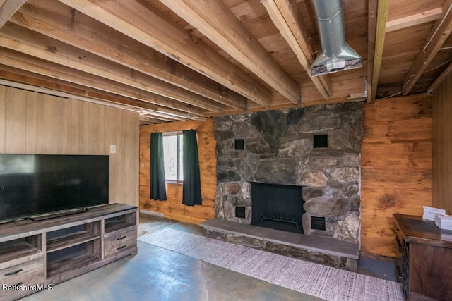 78 Slope Rd, Tolland, MA 01034 - unfurnished living room with wooden walls, concrete flooring, and a fireplace