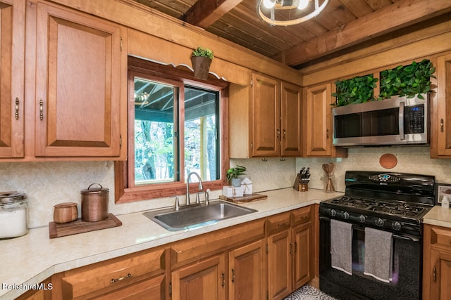 78 Slope Rd, Tolland, MA 01034 - kitchen with black gas stove, stainless steel microwave, a sink, wooden ceiling, and light countertops
