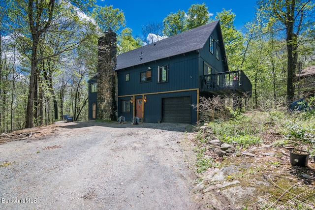 78 Slope Rd, Tolland, MA 01034 - view of front of home featuring driveway, roof with shingles, an attached garage, and a wooden deck
