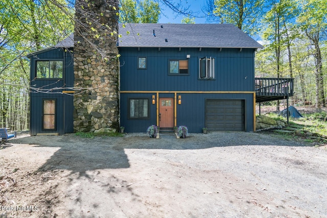 78 Slope Rd, Tolland, MA 01034 - chalet / cabin with roof with shingles, dirt driveway, a chimney, a garage, and a deck