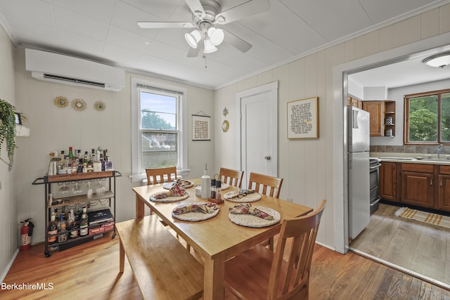 7 Chicopee St, Lanesborough, MA 01237 - dining room with a wall mounted AC, ornamental molding, light wood-type flooring, and a ceiling fan