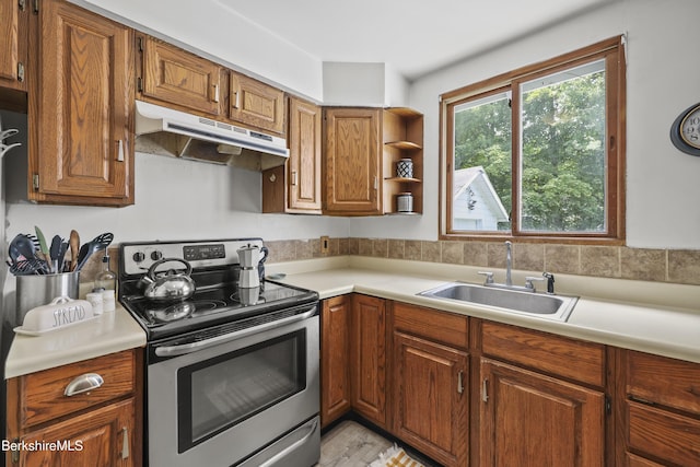 7 Chicopee St, Lanesborough, MA 01237 - kitchen with stainless steel electric range, under cabinet range hood, light countertops, brown cabinetry, and open shelves