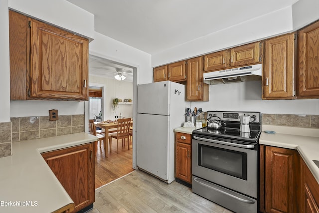 7 Chicopee St, Lanesborough, MA 01237 - kitchen featuring under cabinet range hood, electric stove, freestanding refrigerator, a ceiling fan, and light wood-style flooring