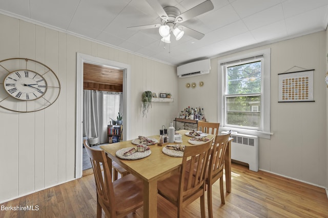 7 Chicopee St, Lanesborough, MA 01237 - dining room featuring a wall mounted AC, radiator, crown molding, light wood-type flooring, and a ceiling fan