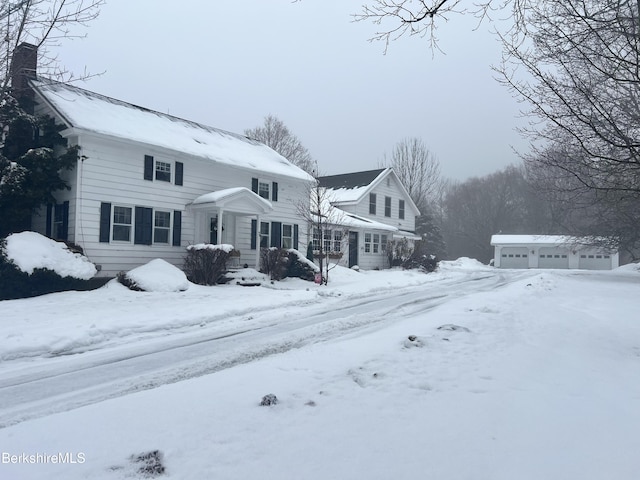 view of front of property featuring a garage and an outdoor structure