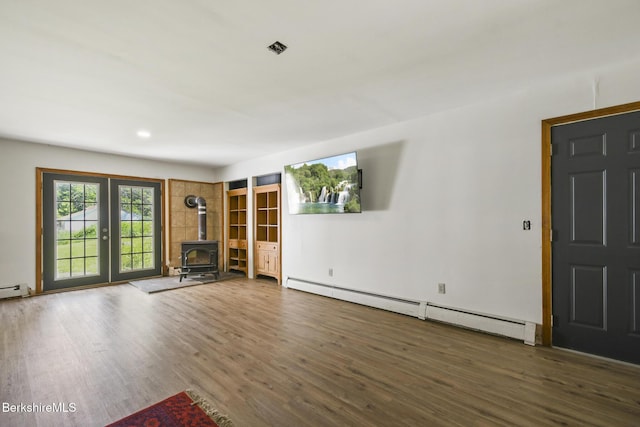 20 E Dugway Rd, Lenox, MA 01240 - unfurnished living room with baseboard heating, wood finished floors, and a wood stove