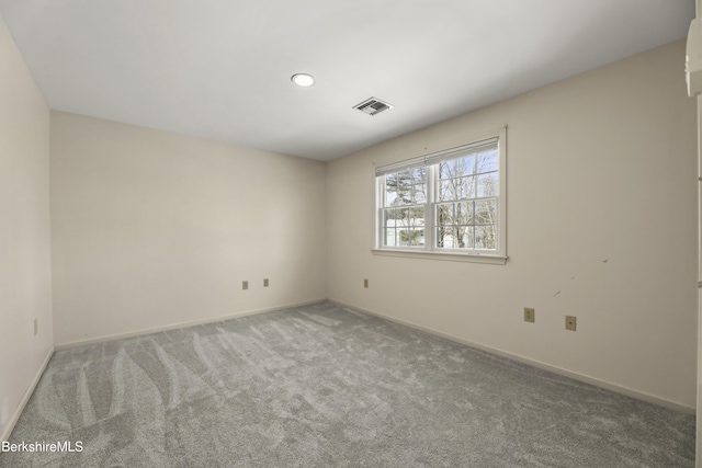 carpeted empty room with baseboards and visible vents