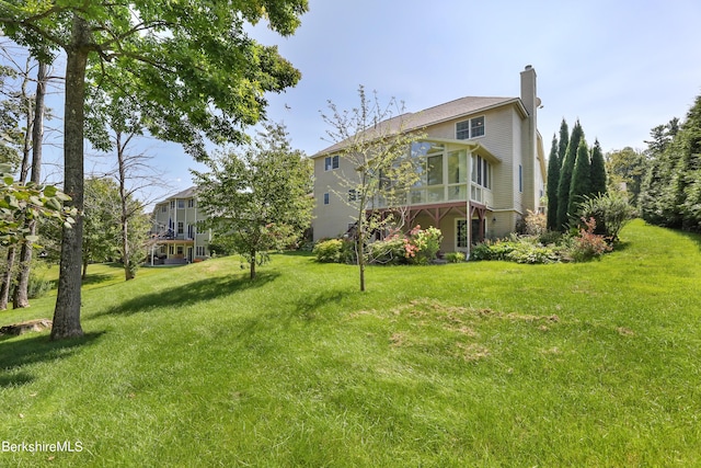 view of yard featuring a sunroom