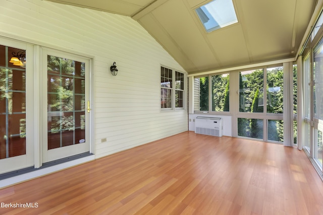 unfurnished sunroom featuring vaulted ceiling with skylight