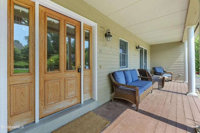 view of exterior entry featuring covered porch