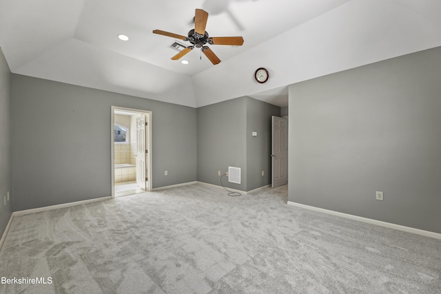 unfurnished bedroom with lofted ceiling, light colored carpet, visible vents, and baseboards