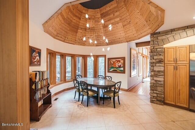 116 Brush Hill Rd, Great Barrington, MA 01230 - dining area with light tile patterned floors, a towering ceiling, french doors, baseboards, and a chandelier