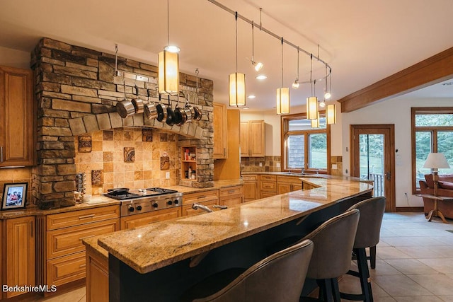 116 Brush Hill Rd, Great Barrington, MA 01230 - kitchen featuring stainless steel gas stovetop, backsplash, a sink, and a kitchen breakfast bar