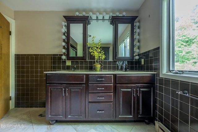 33 Interlaken Rd, Stockbridge, MA 01262 - bathroom with tile walls, tile patterned flooring, a towel warmer, double vanity, and baseboard heating