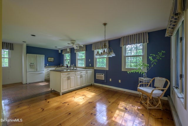 33 Interlaken Rd, Stockbridge, MA 01262 - kitchen with white fridge with ice dispenser, healthy amount of natural light, baseboard heating, and light wood-type flooring