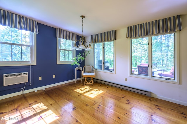 33 Interlaken Rd, Stockbridge, MA 01262 - unfurnished room with baseboard heating, a chandelier, plenty of natural light, and wood-type flooring