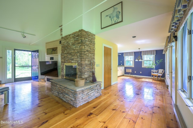 33 Interlaken Rd, Stockbridge, MA 01262 - unfurnished living room featuring a fireplace, hardwood / wood-style floors, and a high ceiling