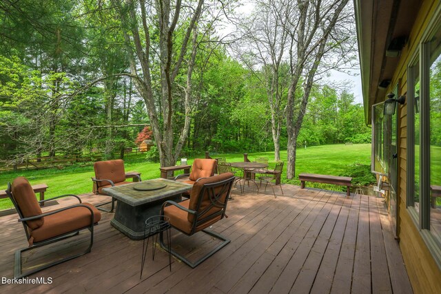 33 Interlaken Rd, Stockbridge, MA 01262 - wooden deck featuring outdoor dining space, a lawn, and a fire pit
