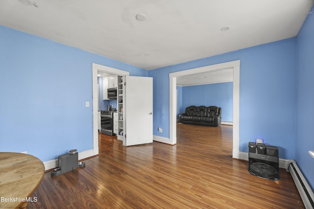 495 Main St, Williamstown, MA 01267 - unfurnished living room with a baseboard radiator, wood finished floors, a baseboard heating unit, and baseboards