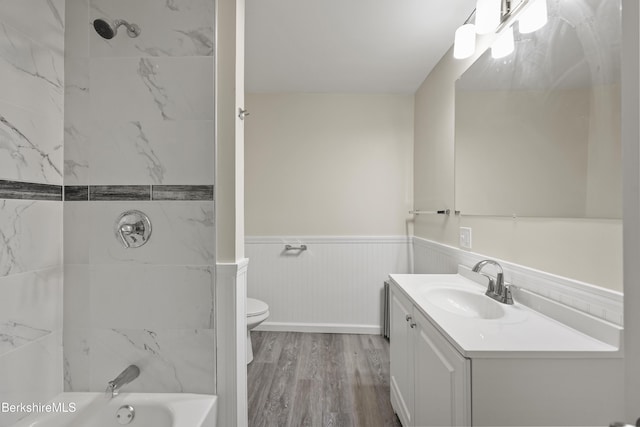 32 Hampshire St, Pittsfield, MA 01201 - bathroom with vanity, wainscoting, wood finished floors, and washtub / shower combination