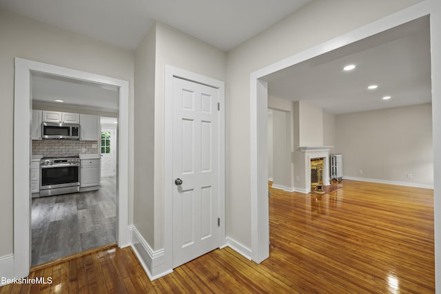 32 Hampshire St, Pittsfield, MA 01201 - hall featuring hardwood / wood-style flooring, radiator, and recessed lighting