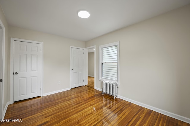 32 Hampshire St, Pittsfield, MA 01201 - unfurnished bedroom featuring radiator and hardwood / wood-style flooring