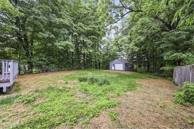 32 Hampshire St, Pittsfield, MA 01201 - view of yard with an outdoor structure, a garage, a deck, and a forest view