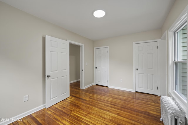 32 Hampshire St, Pittsfield, MA 01201 - unfurnished bedroom with radiator, hardwood / wood-style floors, and multiple windows