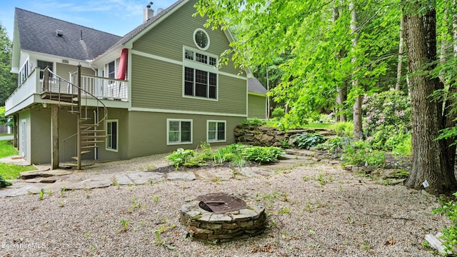 2017 Monterey Rd, Otis, MA 01253 - rear view of house featuring a fire pit, a chimney, a deck, stairs, and a shingled roof