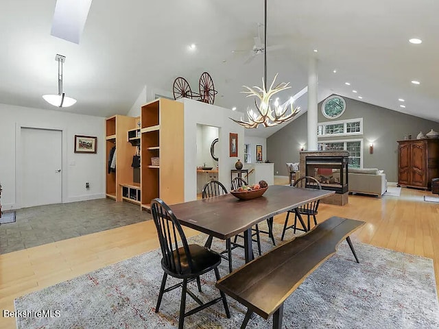 2017 Monterey Rd, Otis, MA 01253 - dining room featuring a chandelier, a fireplace, recessed lighting, high vaulted ceiling, and light wood finished floors