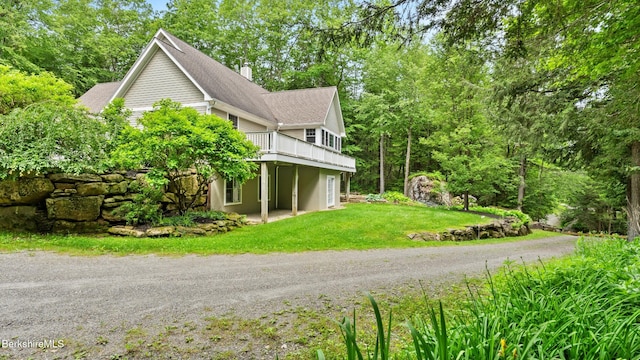2017 Monterey Rd, Otis, MA 01253 - view of side of home featuring a yard, a deck, and view of scattered trees