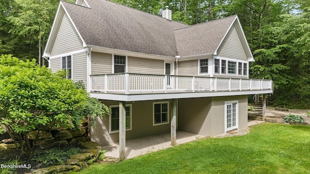 2017 Monterey Rd, Otis, MA 01253 - rear view of house with roof with shingles, a chimney, a wooden deck, a yard, and a patio