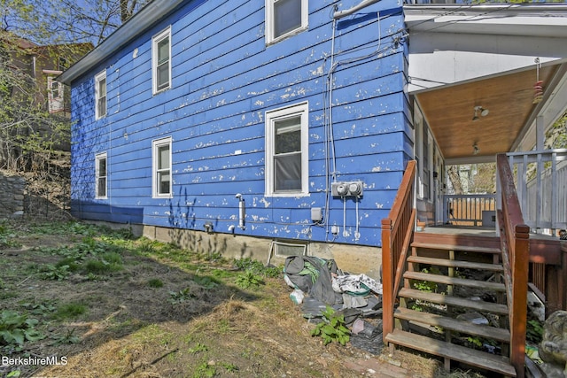 view of side of property with a wooden deck