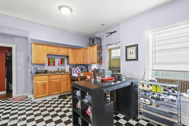 kitchen featuring a sink and tile patterned floors