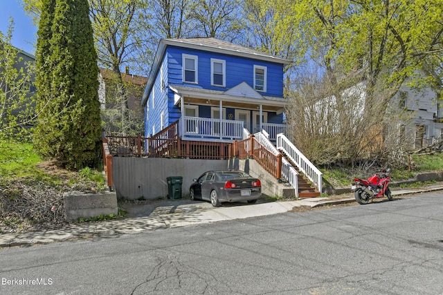 view of front of property with stairs and a porch