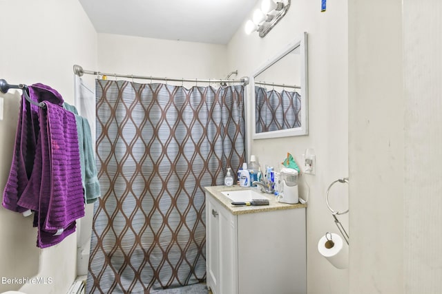 bathroom featuring vanity and curtained shower