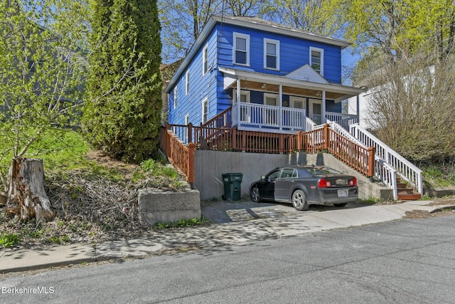 view of front of property with covered porch and stairway