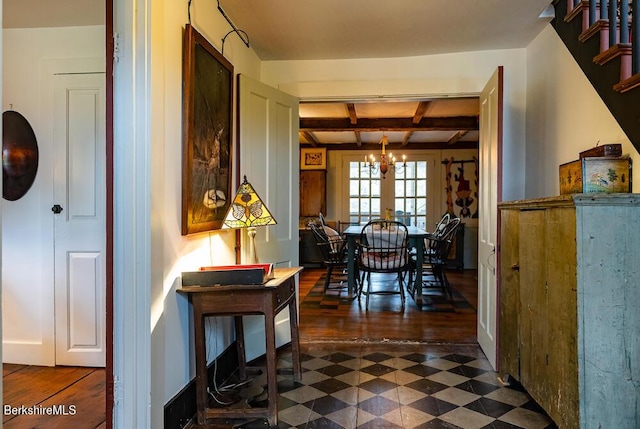 interior space featuring french doors, a notable chandelier, and beam ceiling