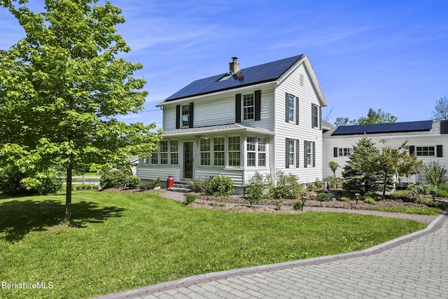 288 Johnson Rd, Dalton, MA 01226 - view of front of house featuring entry steps, solar panels, a chimney, and a front yard