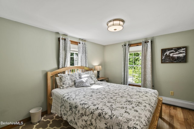 288 Johnson Rd, Dalton, MA 01226 - bedroom with baseboards, multiple windows, wood finished floors, and a baseboard heating unit